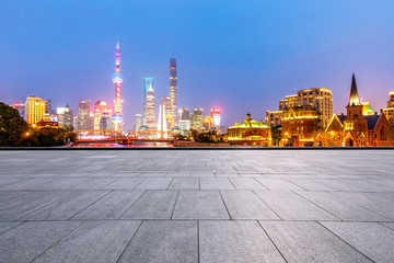 empty square floor and beautiful city skyline at night in shanghai
