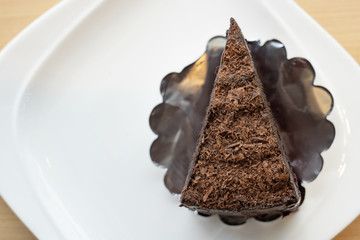 top view, slice of chocolate cake, layer chocolate fudge on withe plate