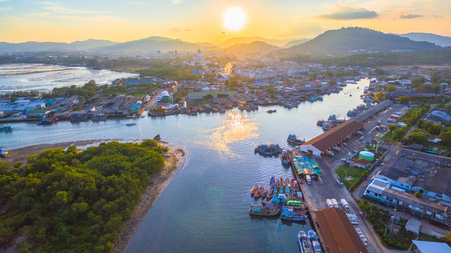 aerial scenery sunset at Siray  fishing port. Phuket Fishing Port is the largest fishing port. Located in Sire Island, next to Phuket Island. There is a large canal leading to the sea.