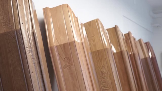 Low angle, coffins leaned against wall