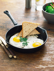 Fried eggs frying pan wooden table Healthy breakfast concept