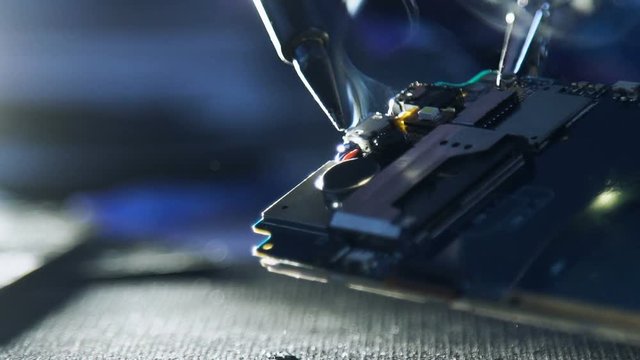 mobile phone hardware engineering. technology science concept. developer soldering smartphone wires