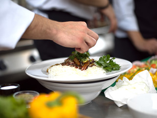 Chef hands serving spaghetti