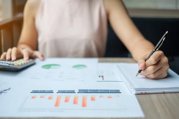 Businesswoman analysis maketing plan, Accountant calculate financial report, with graph chart. ...