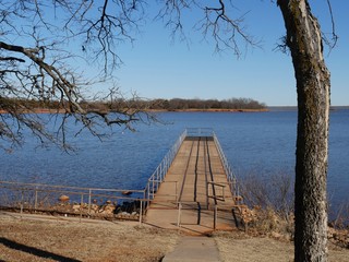 Wooden dock and lookout with railings  Blue waters of Thunderbird Lake State park on a cold day 