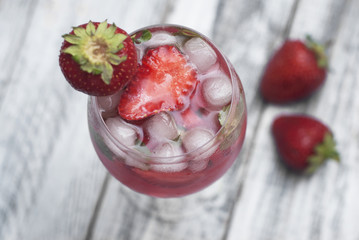 Homemade Delicious Red Sangria with Strawberry Ice Summer Drink Rustic Gray Wooden Background