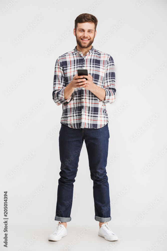 Sticker Full length portrait of a smiling young man