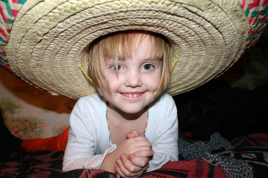 Little Smiling Girl In Sombrero Hat. Close-up