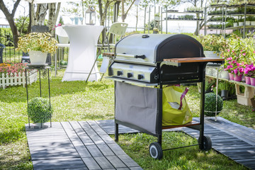barbecue in the garden with flower and decking. gas barbecue.