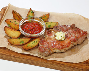 Pork steak with potato wedges and salsa sauce