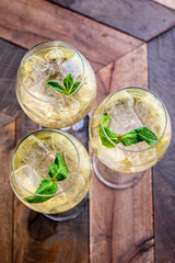 Florence, Tuscany / Italy. - May 14, 2018. A glass of white wine  in a large glass with ice and mint leaves in a bar in Florence, aperitif time