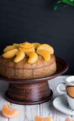 Appetizing pie with tangerines and tasty tea on the table