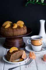 Appetizing pie with tangerines and tasty tea on the table