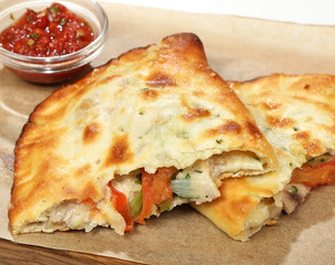 Street food chicken quesadilla (cheese, tomatoes, gherkins, onions, Caesar sauce)