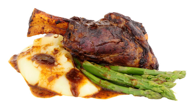 Slow Cooked Lamb Shank Meal With Creamy Mashed Potato And Asparagus Isolated On A White Background