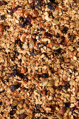 Organic homemade roasted granola with nuts and rasins on baking sheet. Food for breakfast. Meal background, granola texture