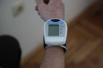 Checking Blood Pressure. Close up view of a blood pressure monito on hand. Digital tonometr on...