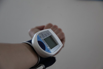 Checking Blood Pressure. Close up view of a blood pressure monito on hand. Digital tonometr on...