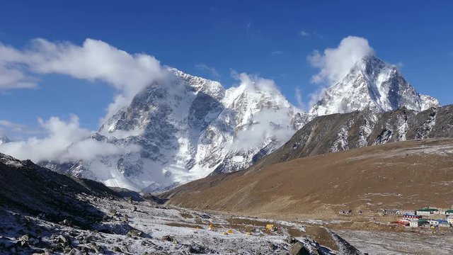 Magnificent view of Cholatse peak (6440 m) and Taboche peak (6495 m) on the background of blue sky at sunrise.  Nepal, Himalaya mountains.