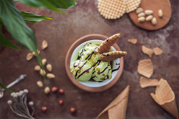 top view of pistachio ice cream with waffles in glass on tabletop