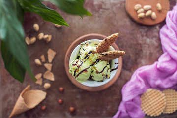 top view of delicious pistachio ice cream with waffles in glass on table