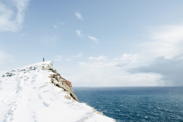 Lonely man silhouette on mountain peak. Latrabjarg, Iceland