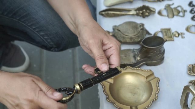 Woman at the flea market select souvenir