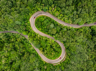 Cars on road. Extrem winding road in the middle of the forest, Carpathian Mountains