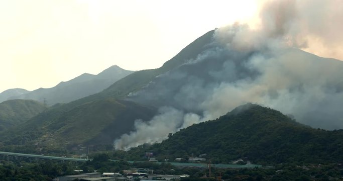 Fire accident in the mountain under sunset
