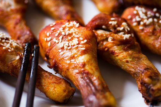 Roasted chicken drumsticks covered with sesame
