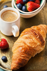 Breakfast setting with coffee and croissant