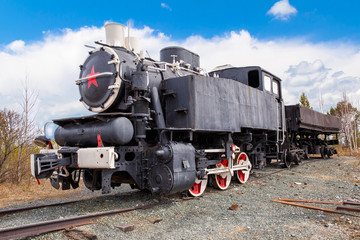 Fototapeta na wymiar Old Soviet steam locomotive with a red star