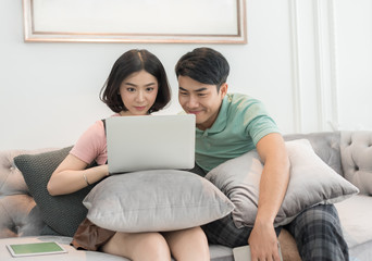 Couple Use Laptop Computer Together In Living Room, Happy Smiling Woman,