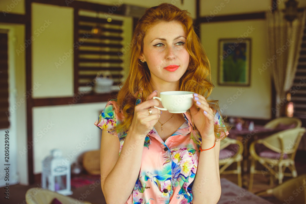 Wall mural Woman in vintage dress, 1950s style interior, retro style in modern life, pretty girl look nice and rest on weekend in kitchen 