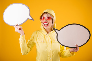 Raincoat woman yellow background. Spech bubles empty copyspace for your dialoge conversation ad texy information