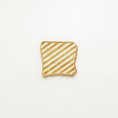 Slice of toast in stripes on white background.