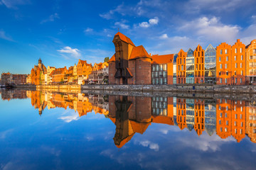 Fototapeta na wymiar Historic port crane of Gdansk reflected in Motlawa river at sunrise, Poland
