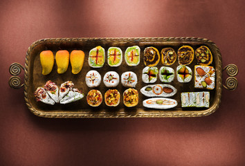 Indian sweets and Mithai in a tray for Diwali festival, flat lay, top view