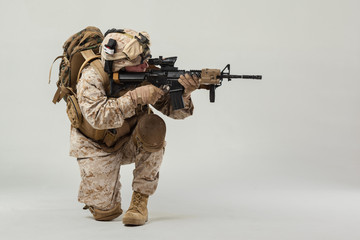 Soldier in camouflage holding rifle