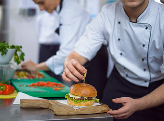 chef finishing burger