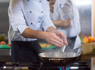 chef preparing food, frying in wok pan