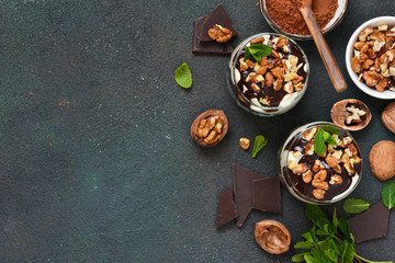 A homemade dessert with vanilla cream, cookies, prunes and nuts.