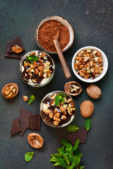 A homemade dessert with vanilla cream, cookies, prunes and nuts.