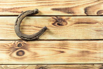 old rusty horseshoes on wooden board