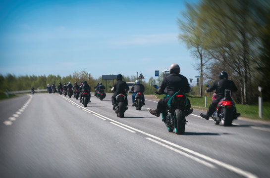 Fototapeta Column of bikers riding on the road.