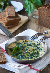Omelette with nettles in a frying pan