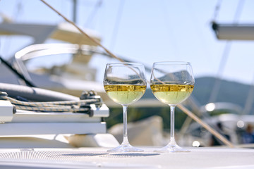 Pair of wineglasses against the yacht
