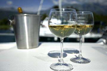 Pair of wineglasses against the yacht