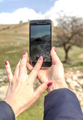 Girl takes pictures of a mountain landscape