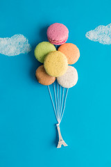 Macaroon balloons with small Eiffel Tower abstract.